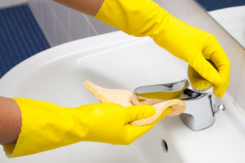 Cleaning staff working in a N2 office kitchen and washroom area